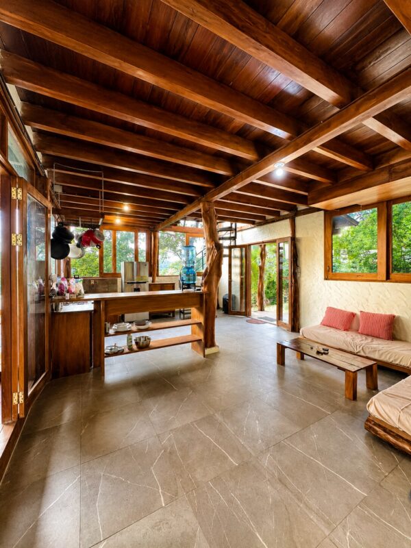 Jungle Retreat Near Playa Yankee living room wrapped in floor-to-ceiling glass with jungle views
