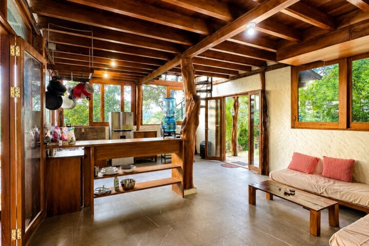 Jungle Retreat Near Playa Yankee living room wrapped in floor-to-ceiling glass with jungle views