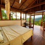 King bedroom with floor-to-ceiling windows over the canopy
