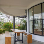 Covered terrace with outdoor dining and columns