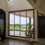 Living space opening to the pool at the Pacific Marlin home