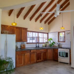 Kitchen beneath vaulted ceilings with radiating wood beams