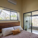 Bedroom with a carved wood headboard and sliding door
