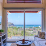 Living room with floor-to-ceiling windows over the bay