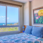 Bedroom with a daybed framed by bay views