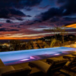 Resort infinity pool at sunset over the Pacific