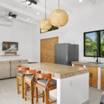 Kitchen island and living area with pendant lighting