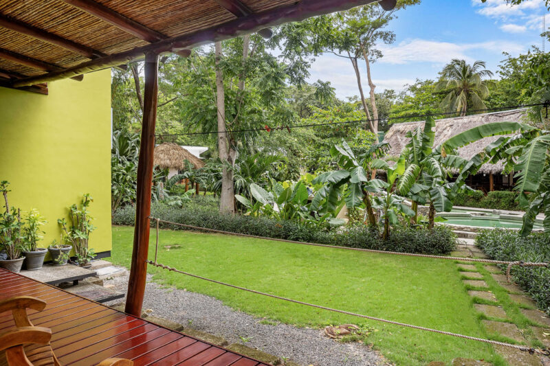 Wood-roofed terrace overlooking the green garden