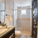 Full bathroom with a walk-in shower and stone vanity