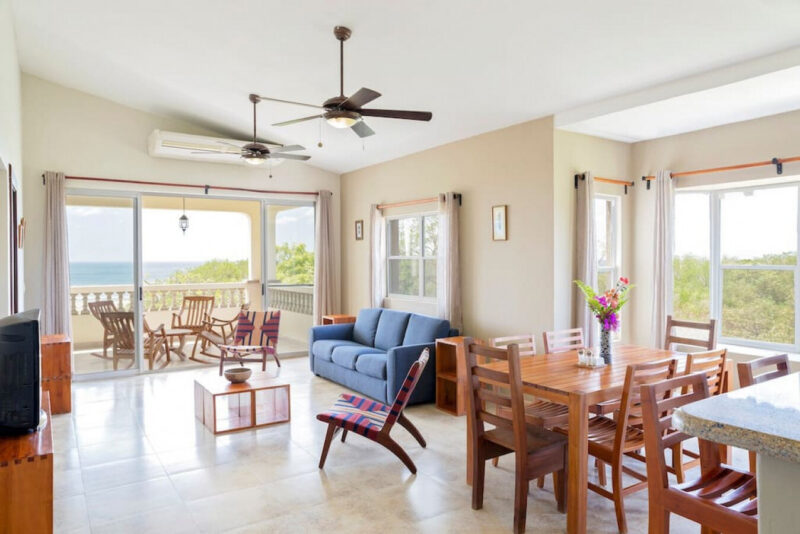 Open living and dining room with ocean views at the Rio Dulce penthouse in Hacienda Iguana