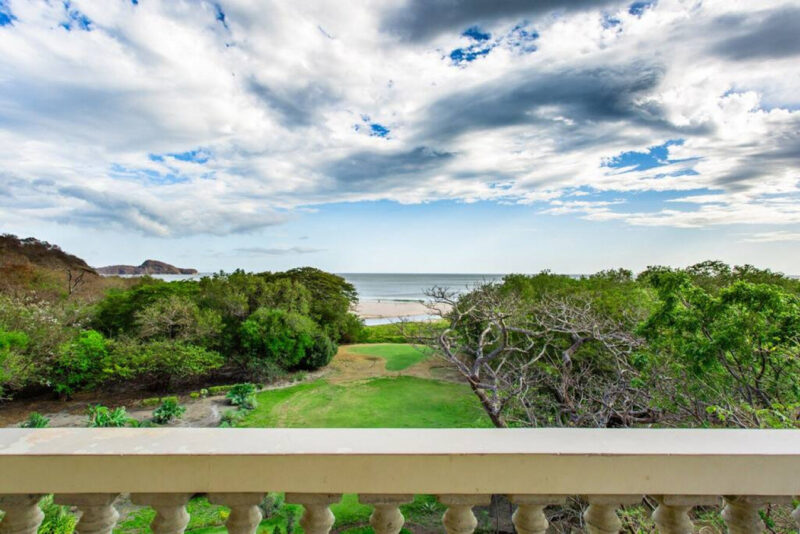 Covered terrace looking over the gardens to the beach at Hacienda Iguana