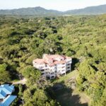 Aerial of the Rio Dulce condominium building set in the jungle