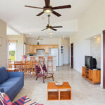 Living area with sofa opening onto the kitchen and dining space