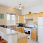 Full kitchen with breakfast bar and wood cabinetry