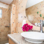 Second bathroom with a vessel sink and stone accents