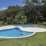 Resort-style pool and landscaped gardens at Hacienda Iguana
