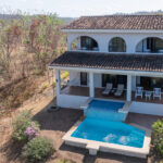 Aerial view of the home, pool, and gardens at Rosada Seascape