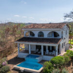 Aerial of the two-level home above the Rancho Santana hills