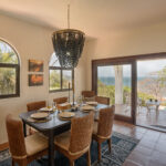 Dining area with an archway and ocean view