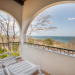 Private balcony with a lounger and framed ocean views