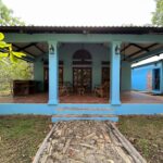 The Turnkey Home at the Surf Sanctuary, a blue colonial-style house