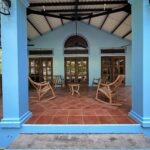 Columned front porch with rocking chairs