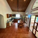 Bright open living and kitchen space with a vaulted ceiling