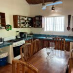Kitchen with wood cabinetry and a dining table