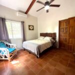 Bedroom with a queen bed and a ceiling fan