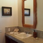 Full bathroom with a tiled vanity and mirror