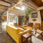 Covered patio lounge with a wood ceiling
