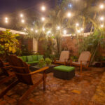 Garden patio at night with string lights
