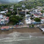 Turnkey hospitality property steps from the beach — aerial to the shoreline
