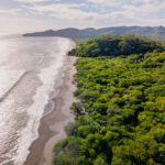 28 acre Pacific beachfront development parcel — aerial over the beach and forested point