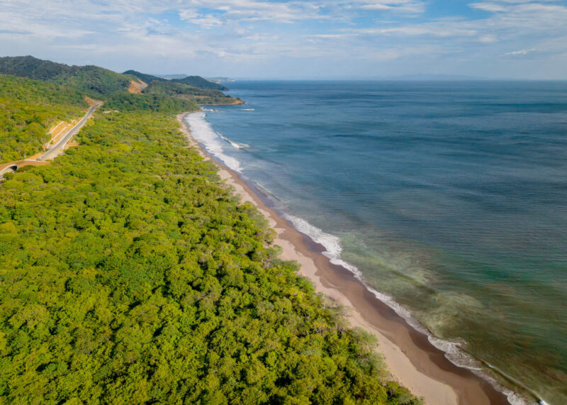 Beachfront and coastal road running along the parcel