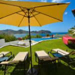 Poolside lawn with lounge seating and ocean view