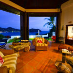 Open living room framing the bay through folding doors
