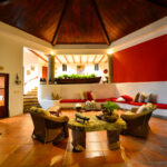 Bay-view home in Pacific Marlin — open-air living pavilion with dark-wood ceiling