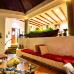 Living pavilion with built-in seating and terracotta floors