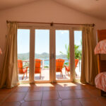 Bedroom opening to a terrace above the bay