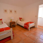 Bay-view home in Pacific Marlin — twin bedroom with tile floors