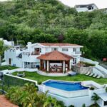 Aerial view of the villa, pool, and living pavilion