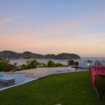 Bay-view home in Pacific Marlin — sunset over the bay from the lawn