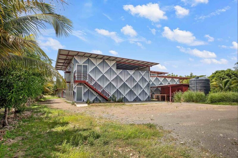 Commercial building on the Costanera Highway with its metal facade and exterior stairs