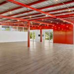 Open interior space with steel beams and a tile floor