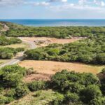 Aerial of the Costanera Highway commercial lot with the ocean and Hacienda Iguana beyond
