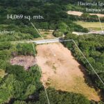 Aerial marking the lot boundary, highway frontage, and Hacienda Iguana entrance