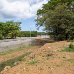Paved Costanera highway running past the lot