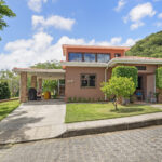 Front exterior of the family home with a driveway on a paved street