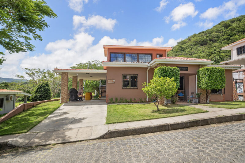 Front exterior of the family home with a driveway on a paved street